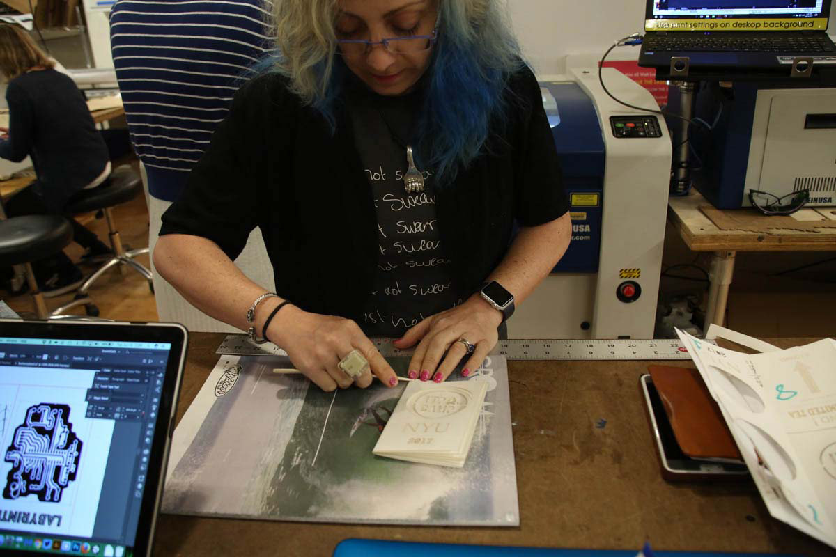 a woman working on her lasercut project